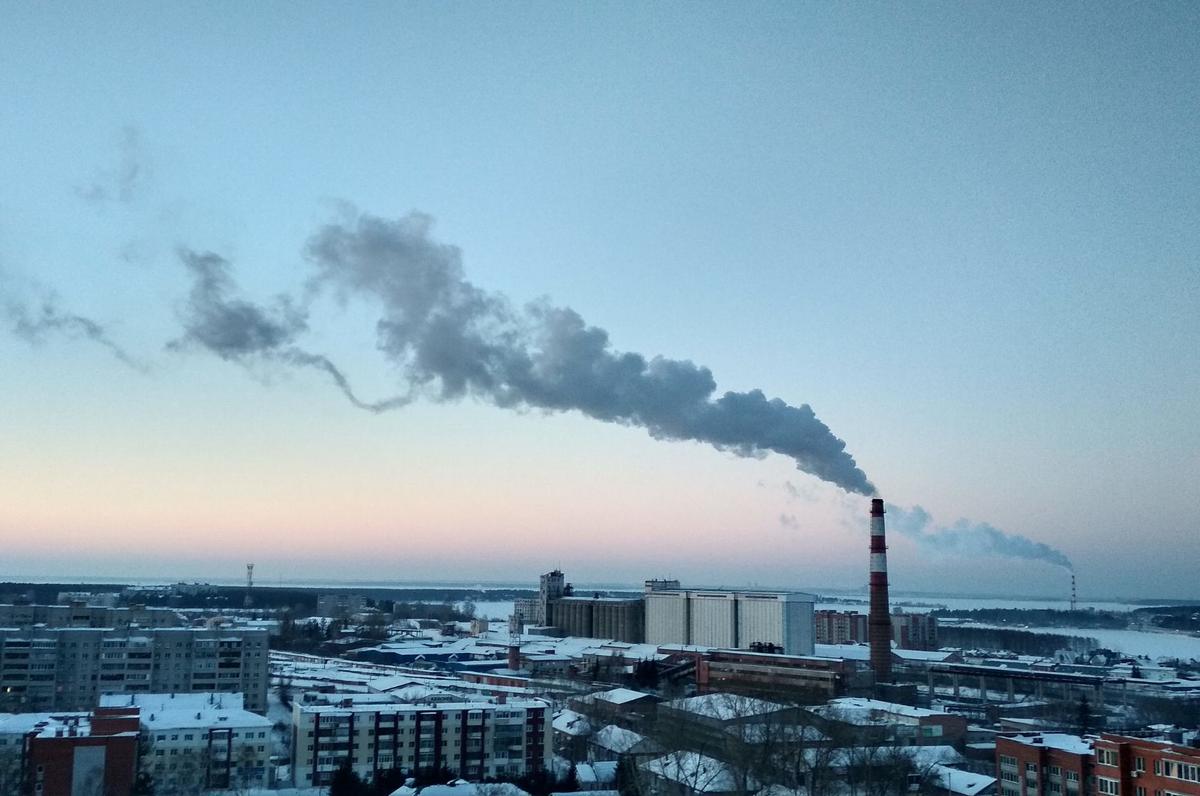 a smoke coming out of a a factory chimney